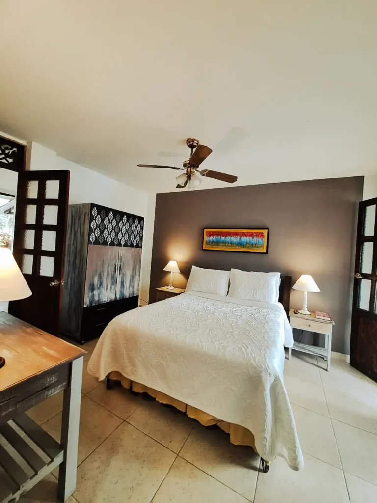 Amplia habitación de alquiler en casa finca hotel Alcalá, con cama doble, muebles de madera y ambiente cálido.